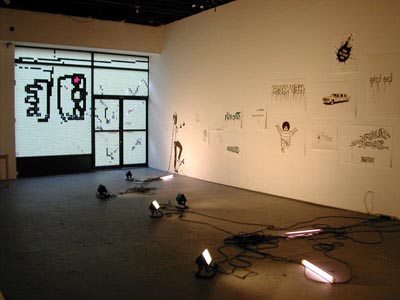 From left to right, Simon Faithfull, <i>Grand</i>, 2002, installation view, postit notes on window; Bruno Peinado, <i>Chic and Underground</i>, 2002, installation view, enamel on sheet rock, enamel on paper, halogen and neon lights
